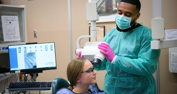 male and female dental assistant students taking oral x-rays