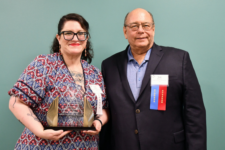 Tracy Figueroa pictured with her award and a representative from CAFE.